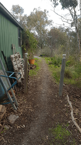Path beside green shed showing access area to position rainwater tank