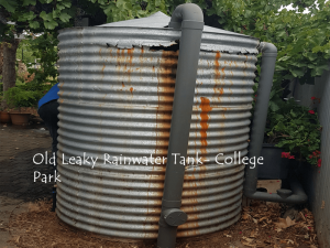 old leaking galvanised iron rainwater tank with rust marks from leaking rainwater